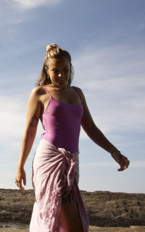 Model wearing Cocou Conscious Couture sleek purple one-piece swimsuit, designed for comfort and eco-friendly elegance. A sustainable one-piece swimsuit.